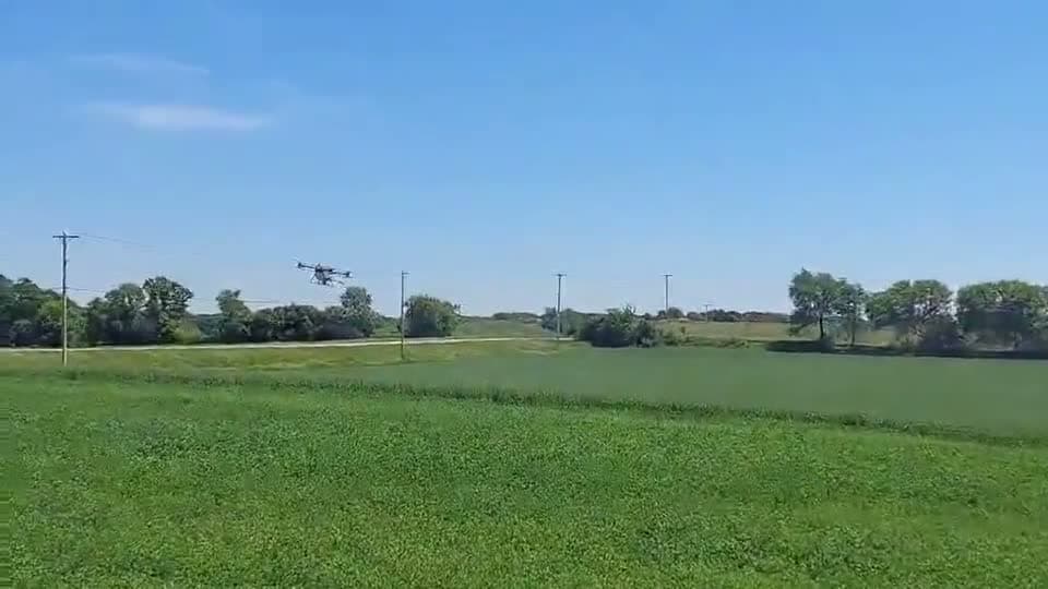 Agriculture drone flying over a green field