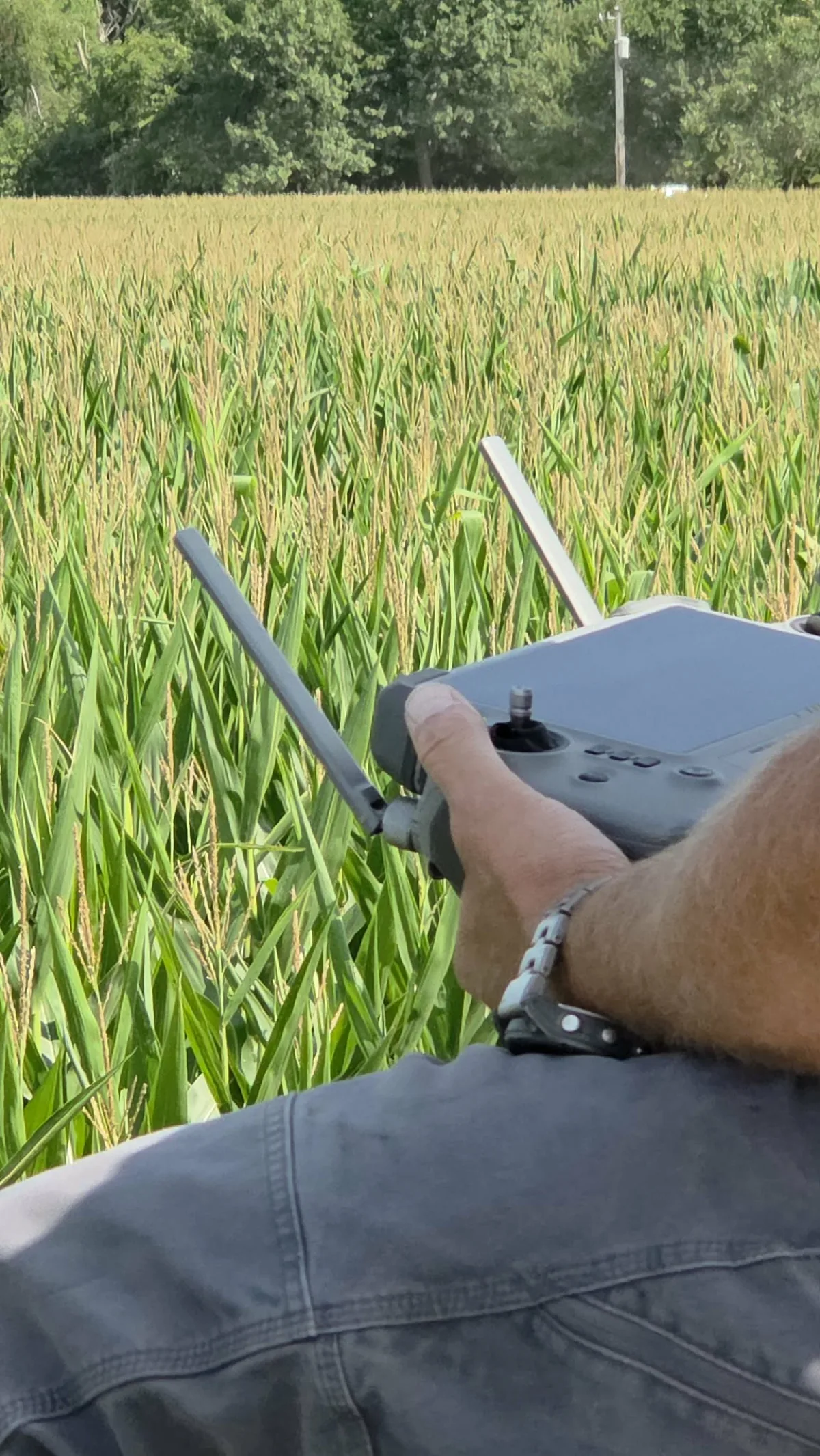 Agriculture drone staged beside planted rows